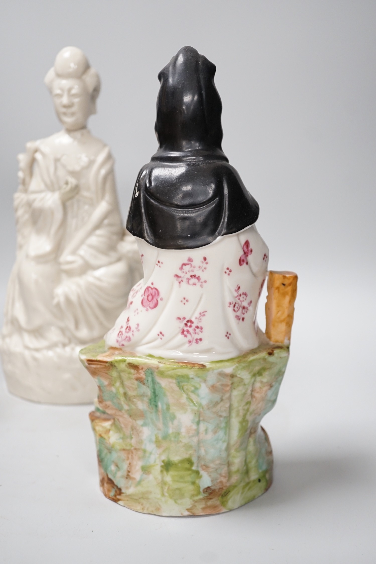 A Chinese enamelled blanc de chine figure of Guanyin, together with three other figures. 28cm tall